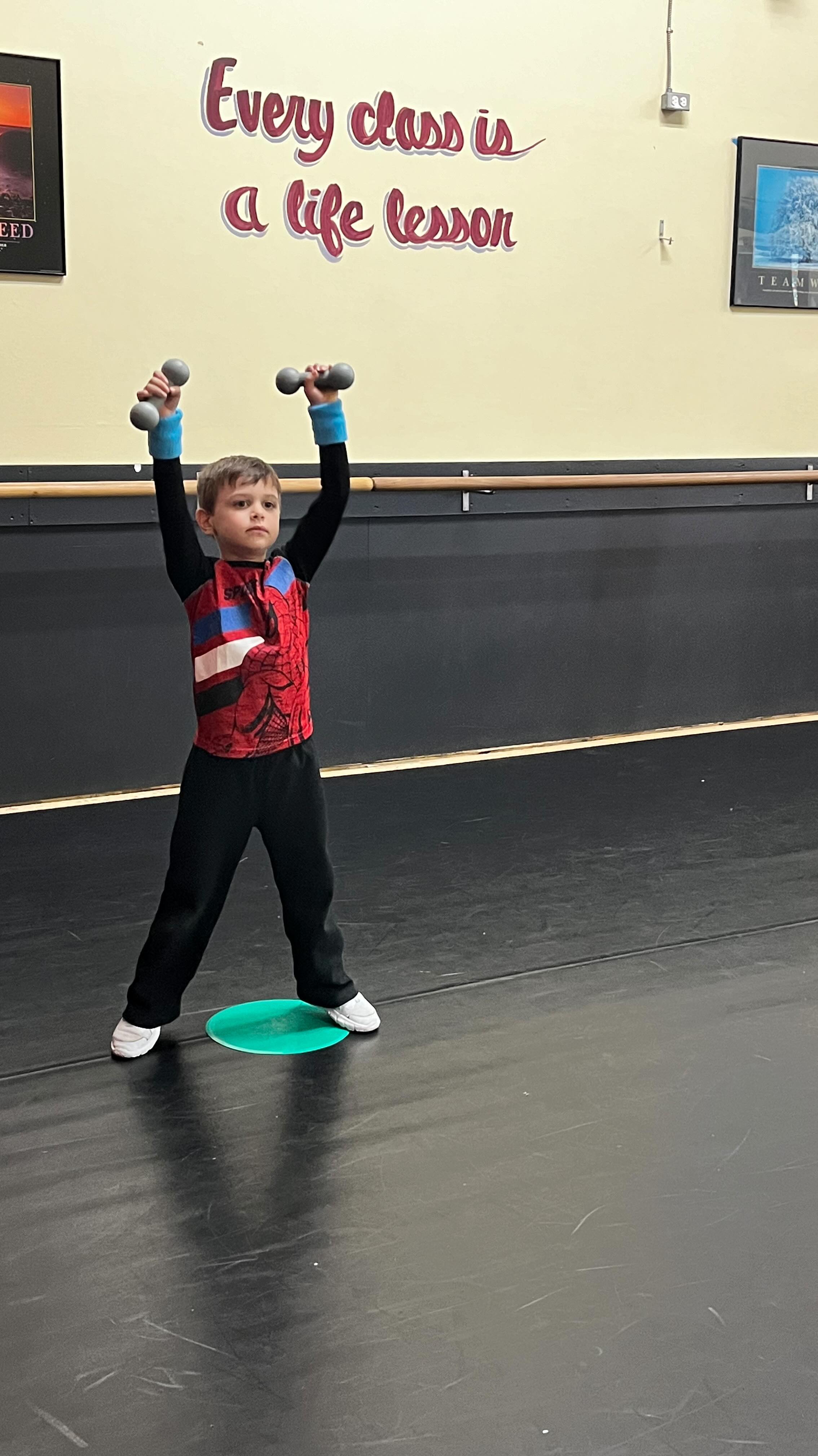 boy lifting weights at studio