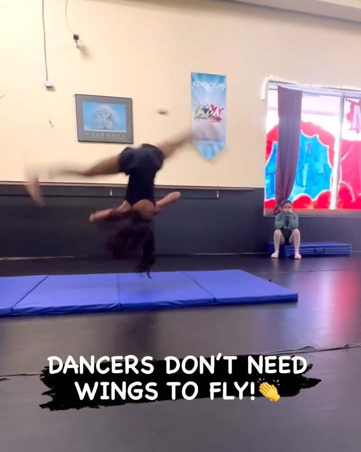 girl doing aerial flip over mat